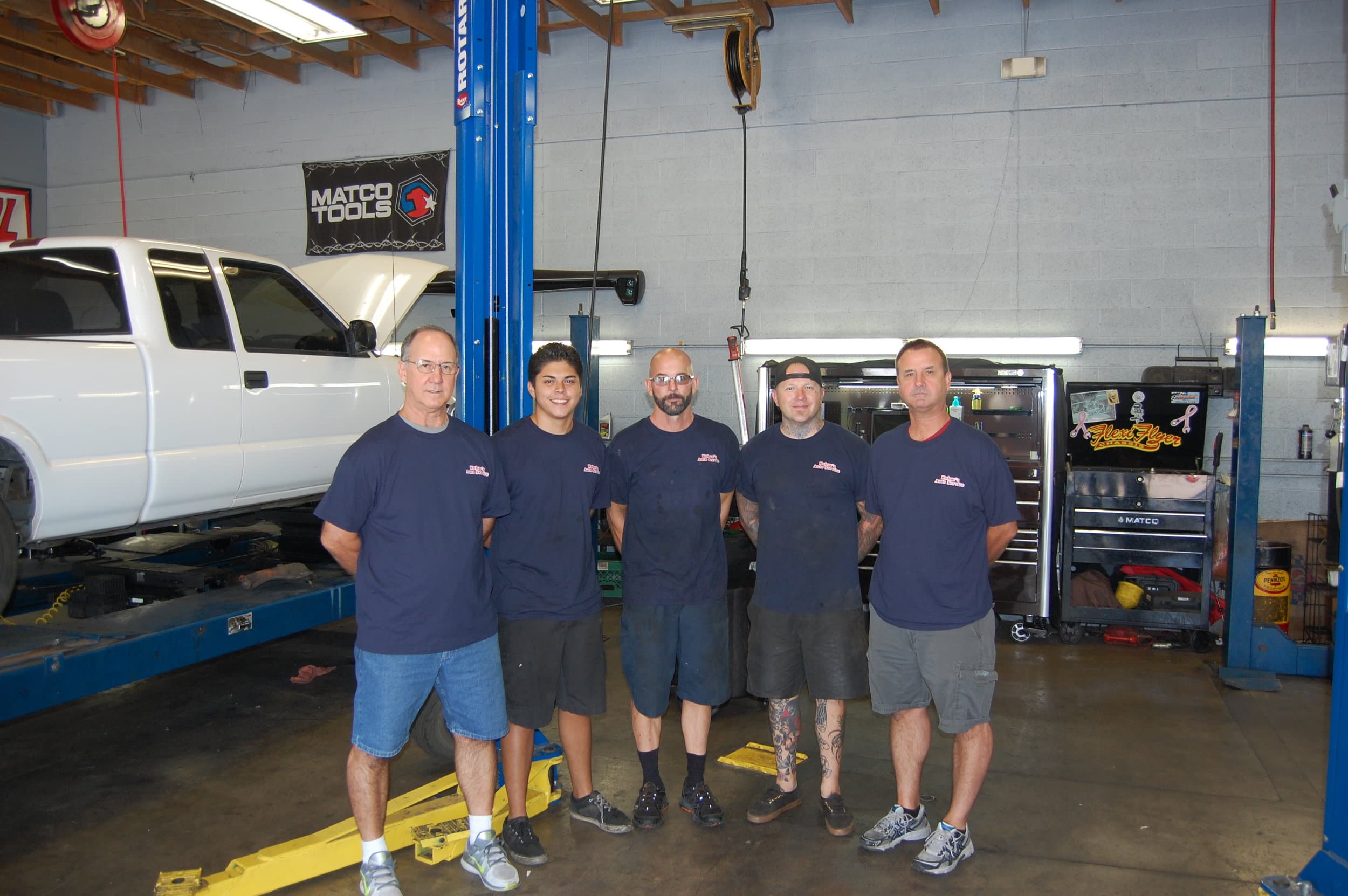Five Kobar's Auto technicians in front of a Matco Tools banner